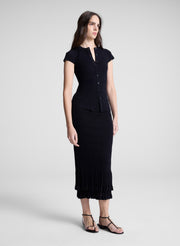 woman wearing black cardigan and black midi skirt
