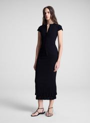 woman wearing black top and matching skirt