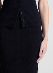 woman wearing black top and matching skirt