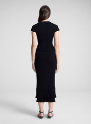 woman wearing black cardigan and black midi skirt