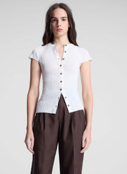 woman wearing white cardigan and brown pants