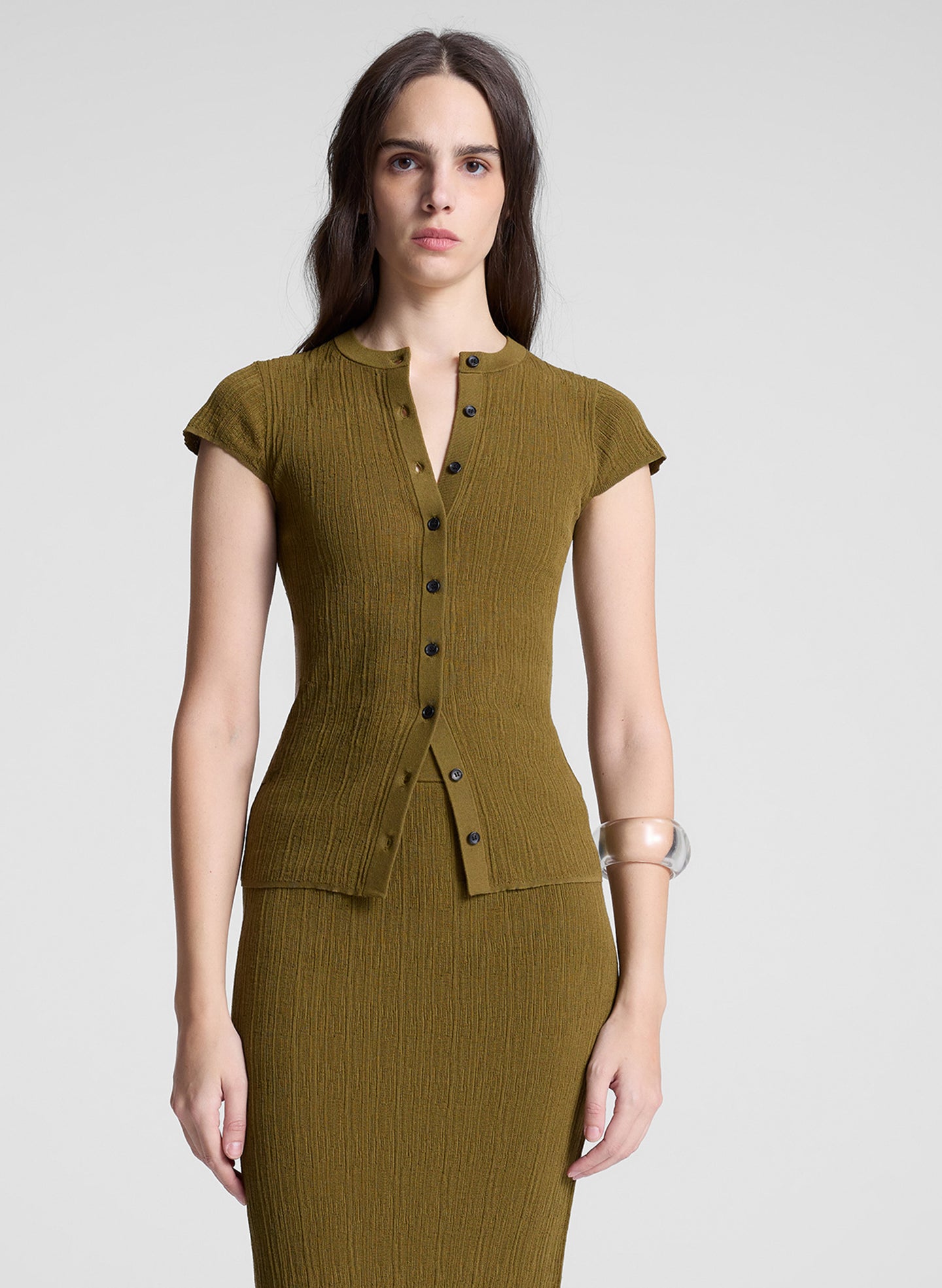 woman wearing brown short sleeve cardigan and matching skirt