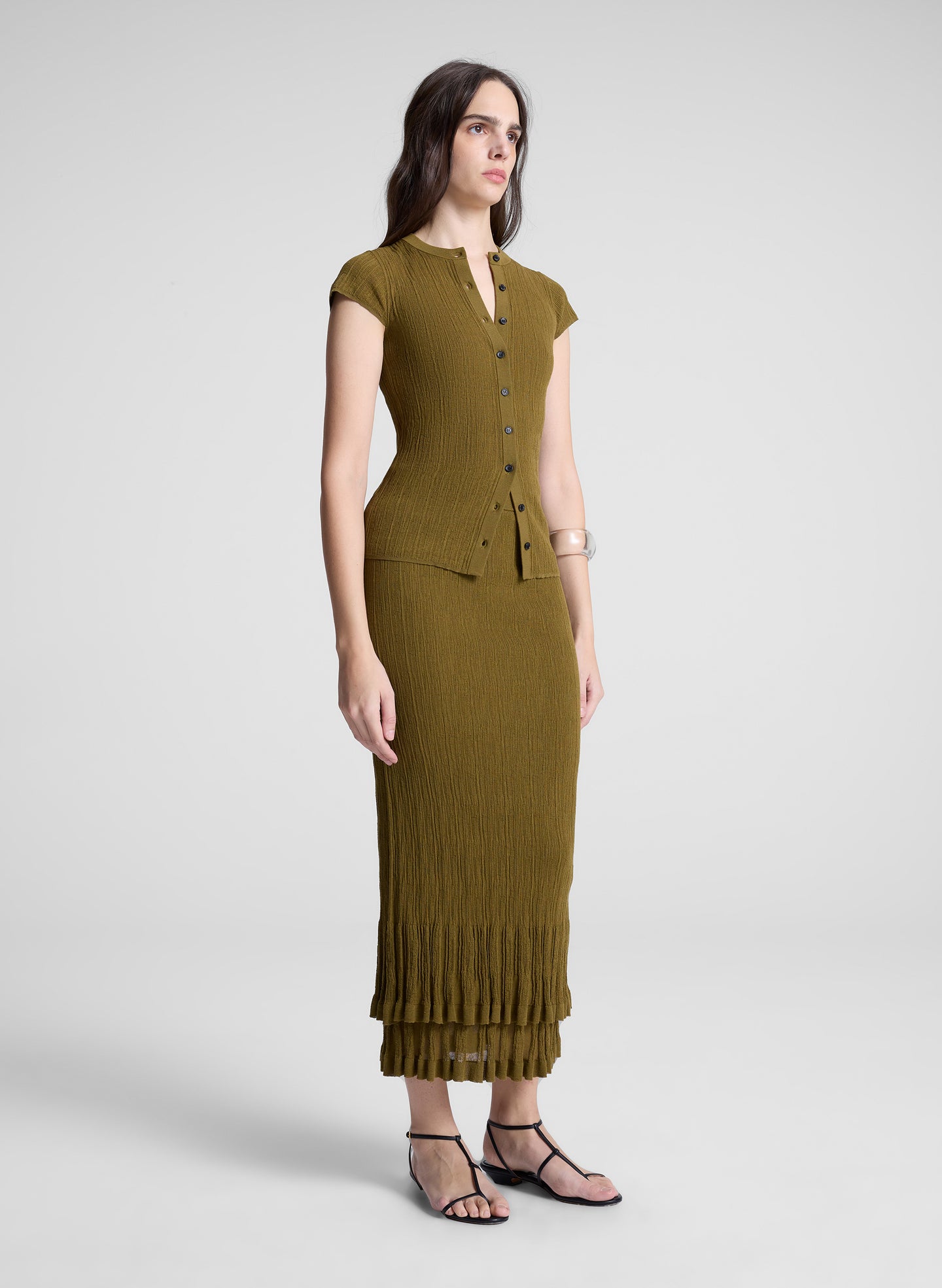 woman wearing brown short sleeve cardigan and matching skirt