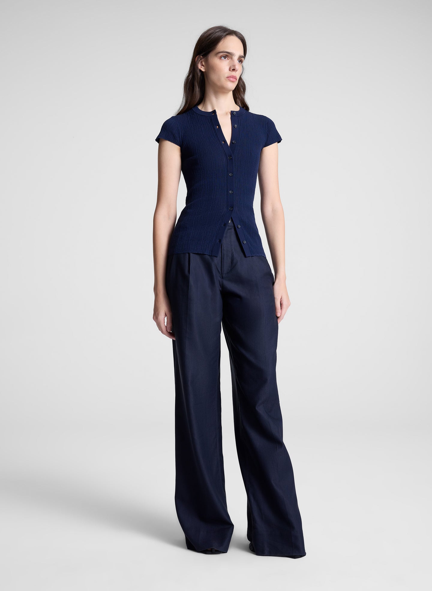 woman wearing navy cardigan and navy pants