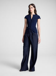 woman wearing navy cardigan and navy pants