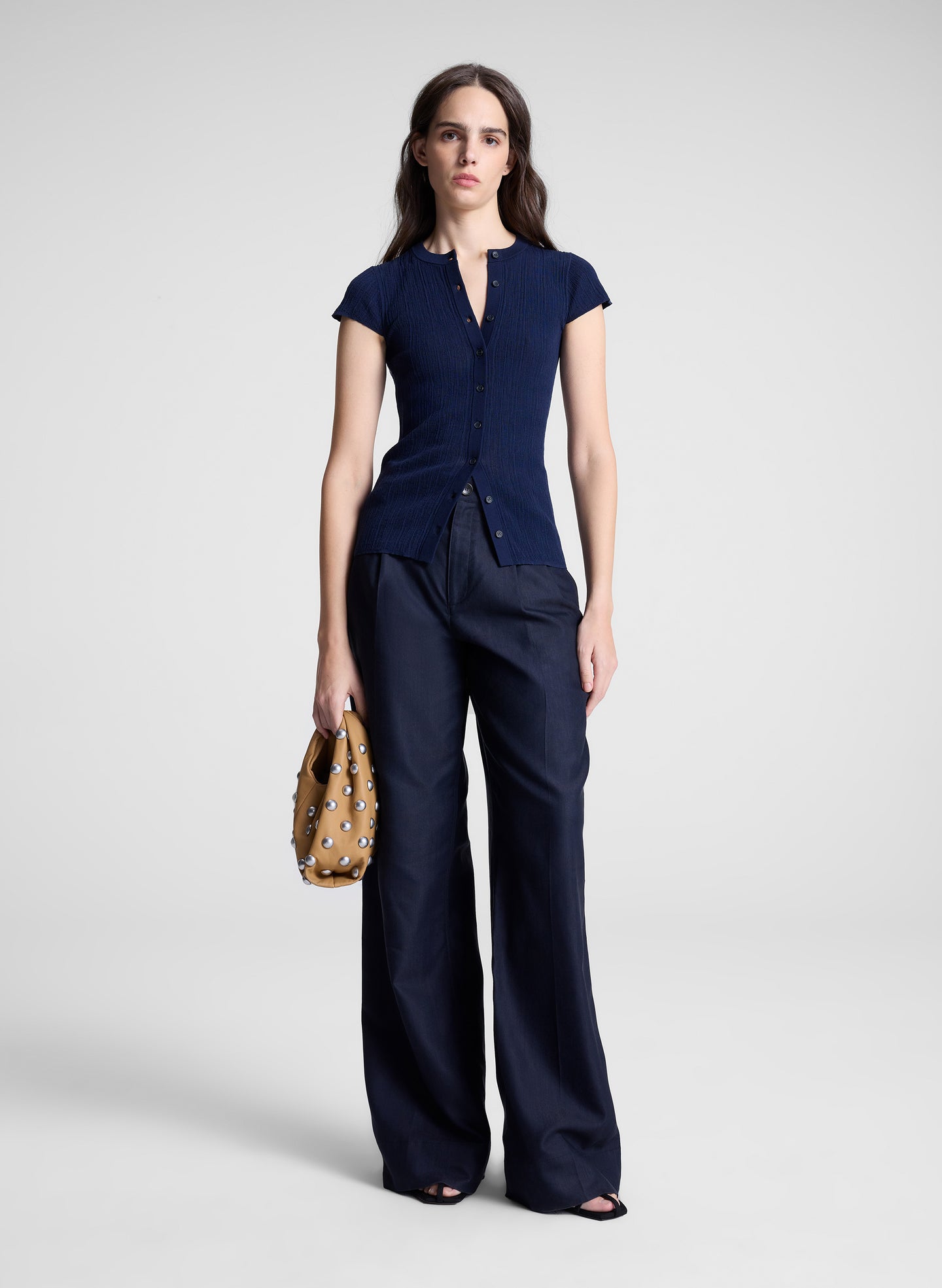 woman wearing navy cardigan and navy pants