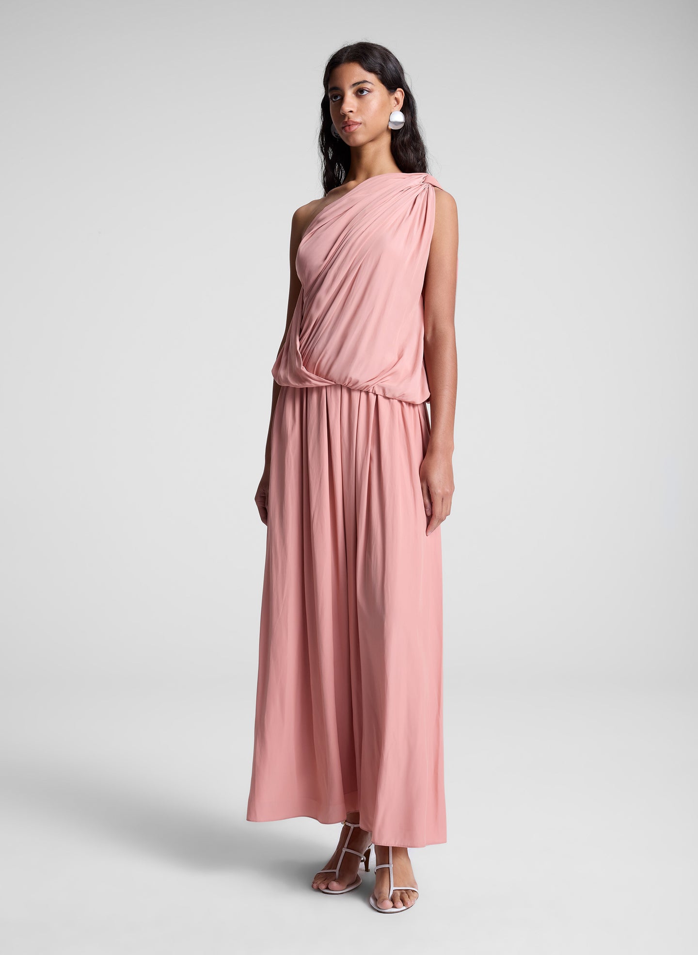 woman wearing pink one shoulder top and matching maxi skirt
