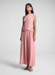 woman wearing pink one shoulder top and matching maxi skirt