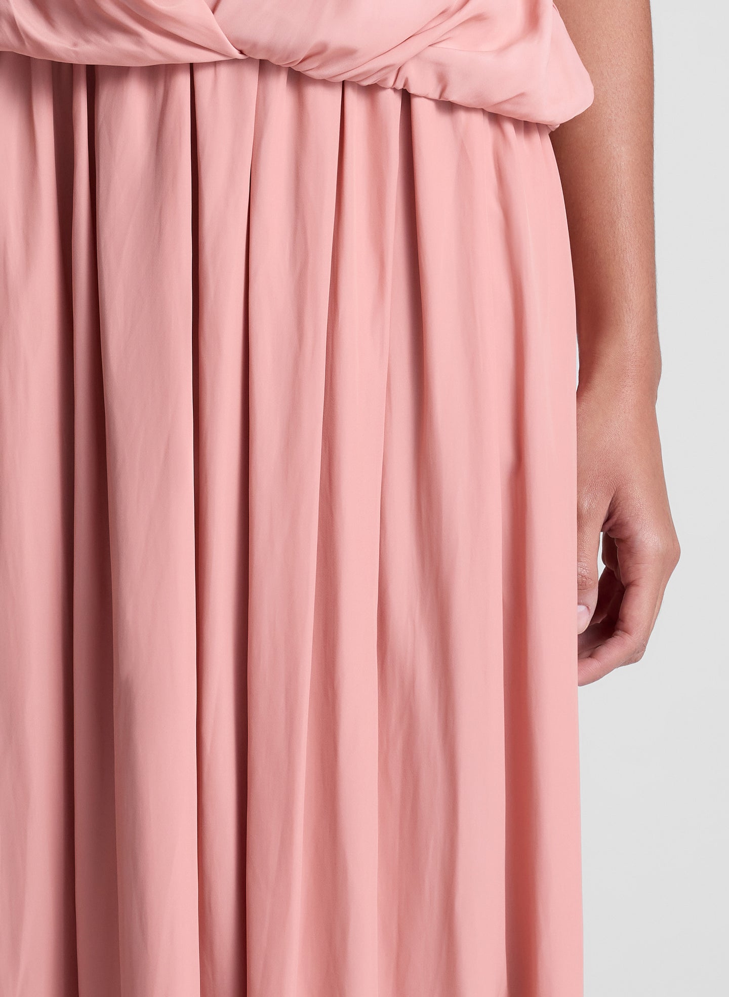 woman wearing pink one shoulder top and matching maxi skirt