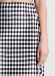 woman wearing black top and black and white gingham midi skirt