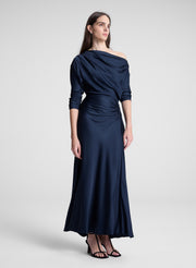 woman wearing navy blue satin maxi dress