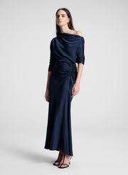 woman wearing navy blue satin maxi dress