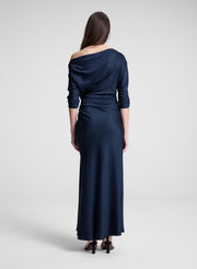 woman wearing navy blue satin maxi dress