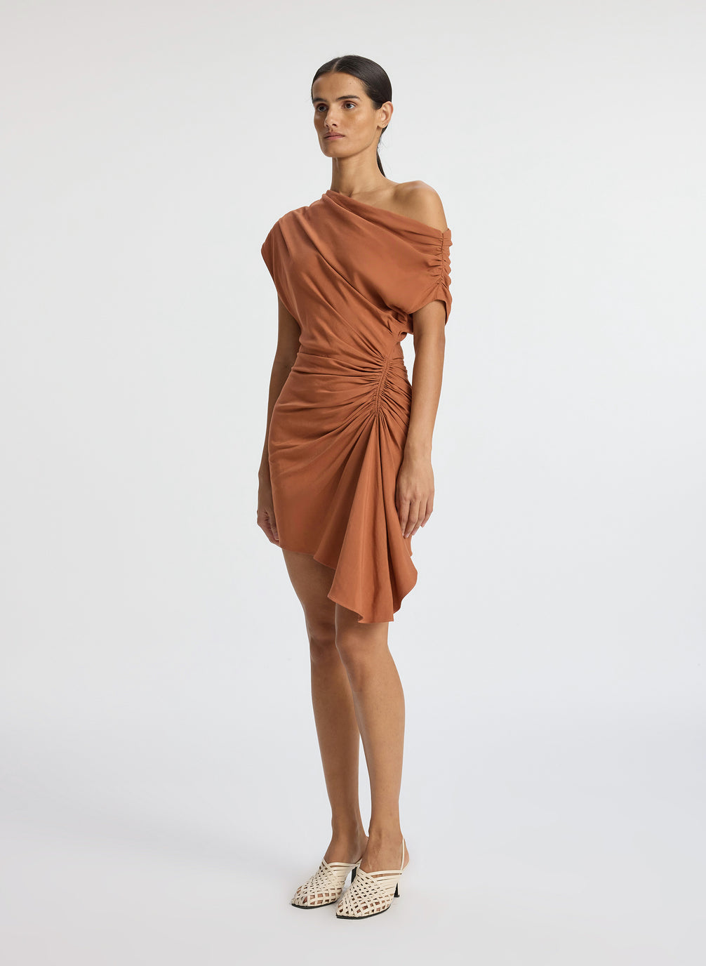 side view of woman wearing brown one shoulder mini dress