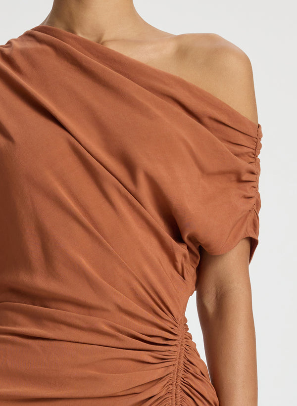 detail view of woman wearing brown one shoulder mini dress