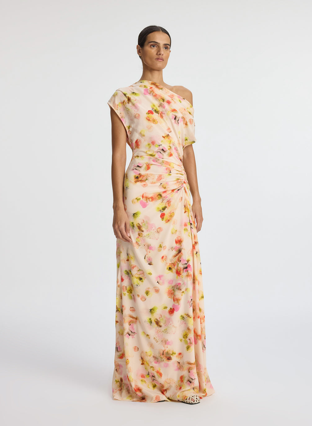 front  view of woman wearing abstract print satin one shoulder maxi dress