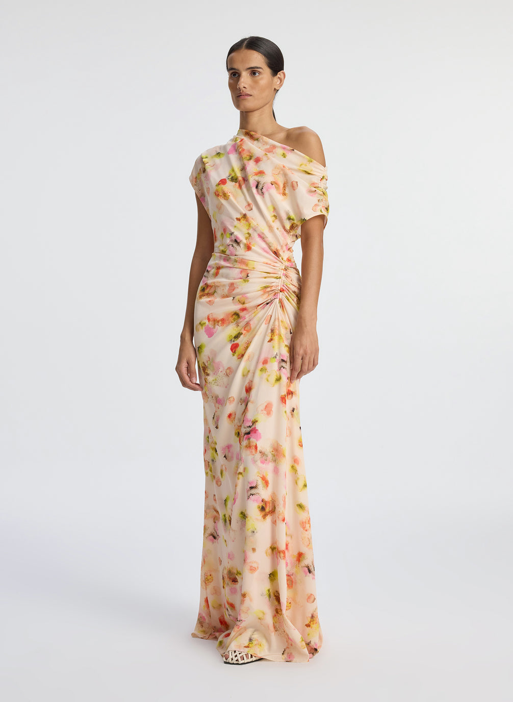 side  view of woman wearing abstract print satin one shoulder maxi dress