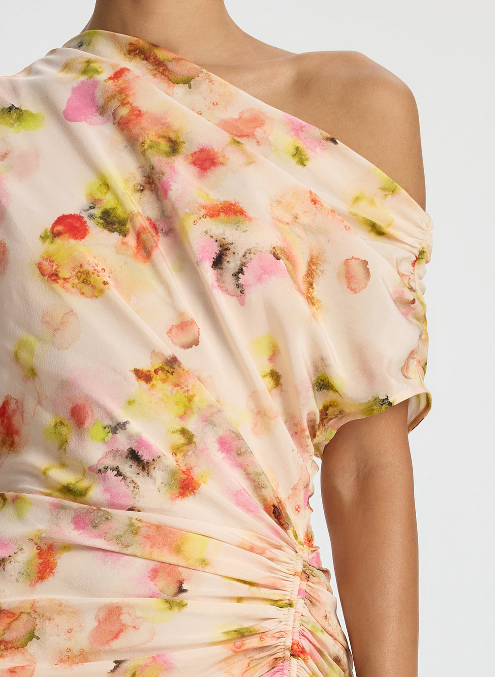 detail  view of woman wearing abstract print satin one shoulder maxi dress