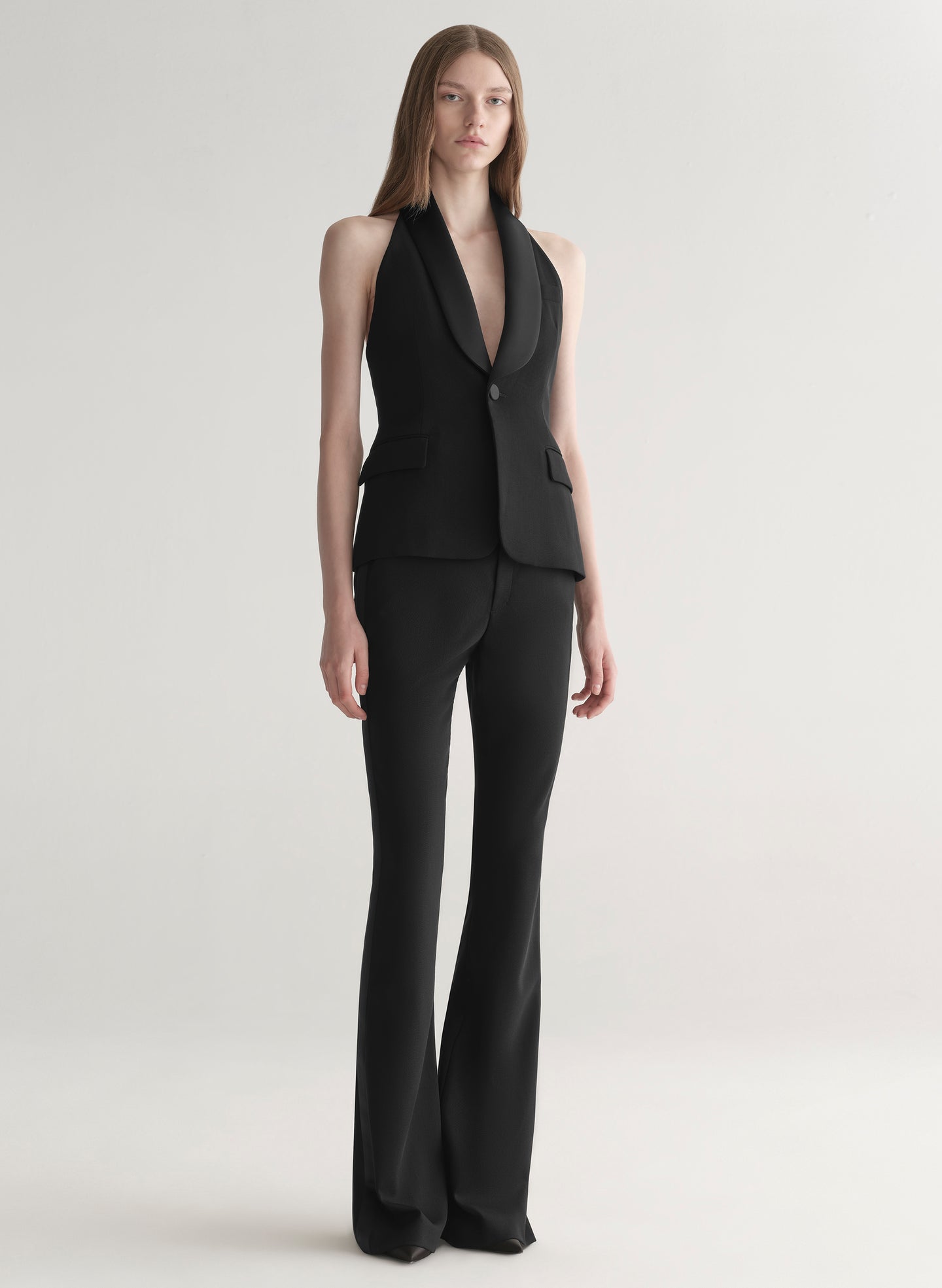 woman wearing black suiting vest with black pants