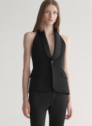 woman wearing black suiting vest with black pants