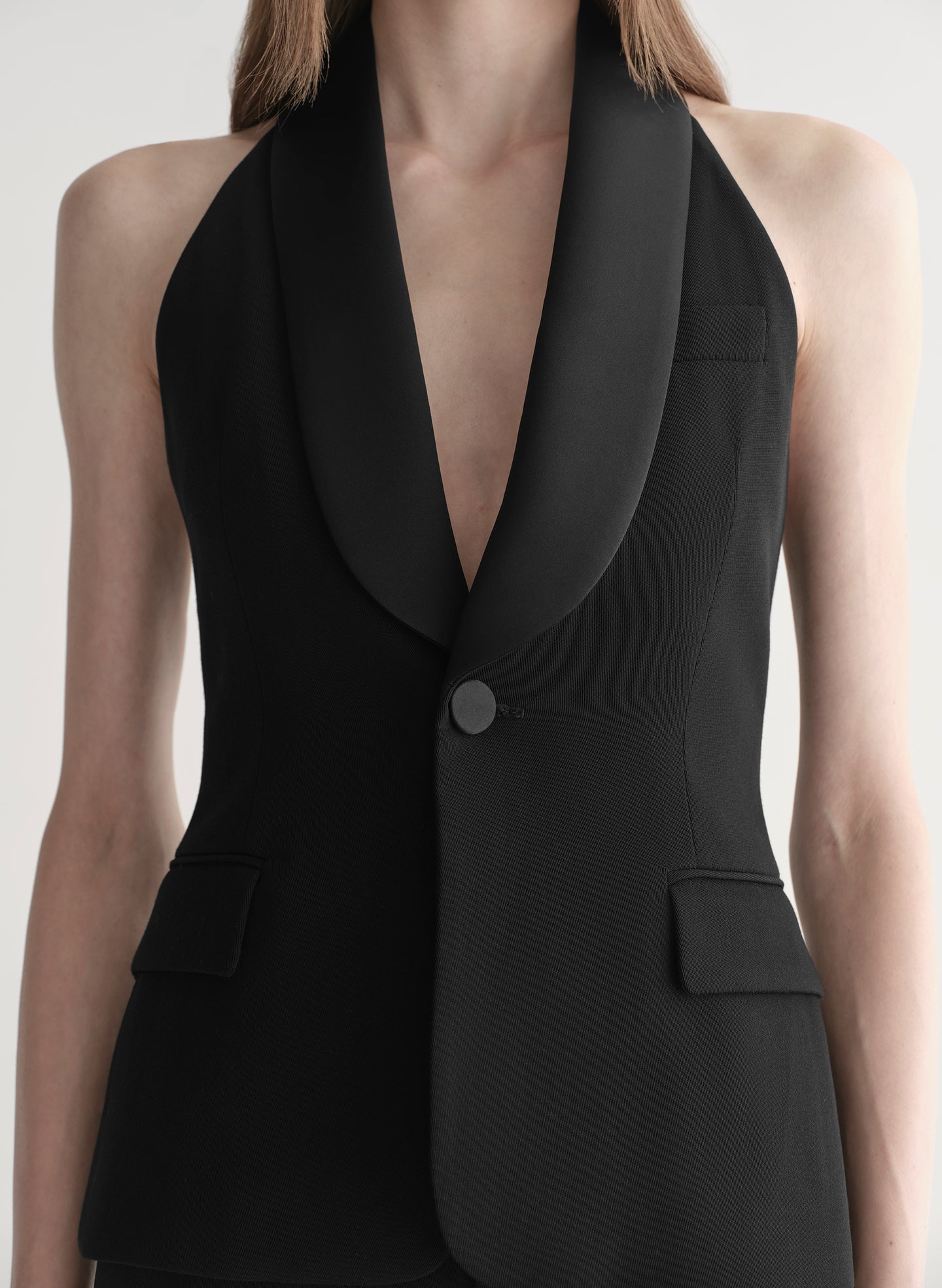 woman wearing black suiting vest with black pants