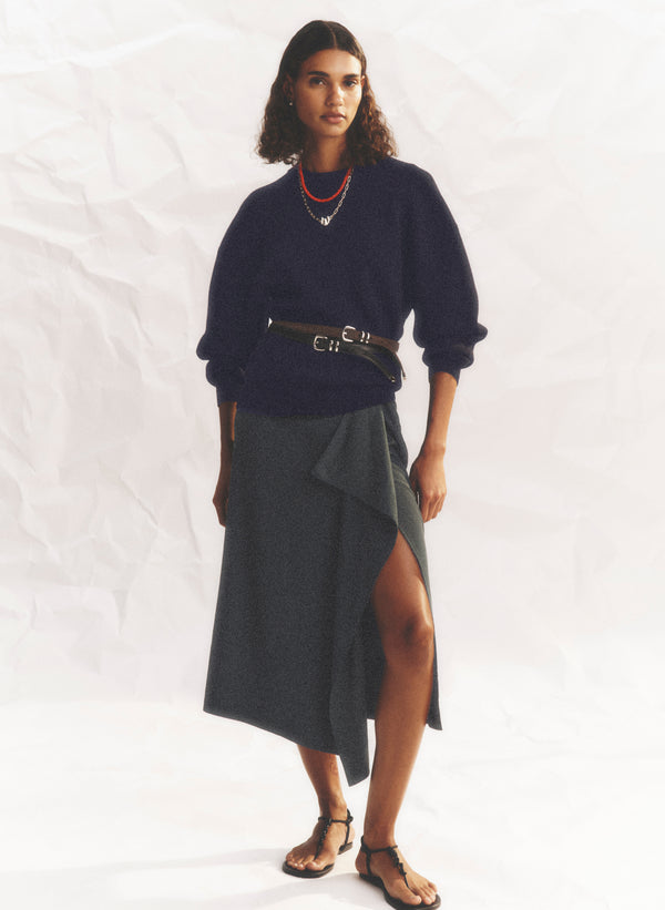woman wearing black sweater and green skirt