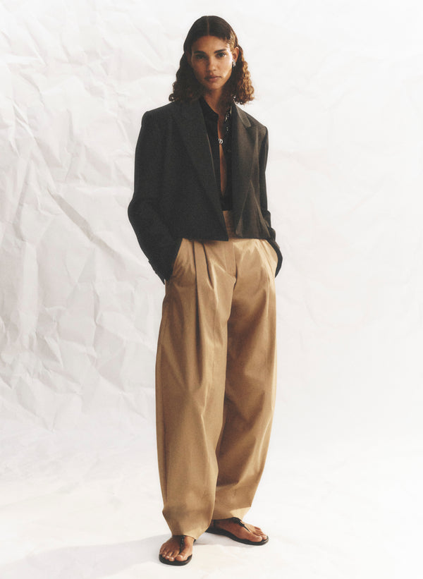 woman wearing cropped blazer and tan pants