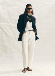 woman wearing white denim jeans, white tee shirt and black blazer