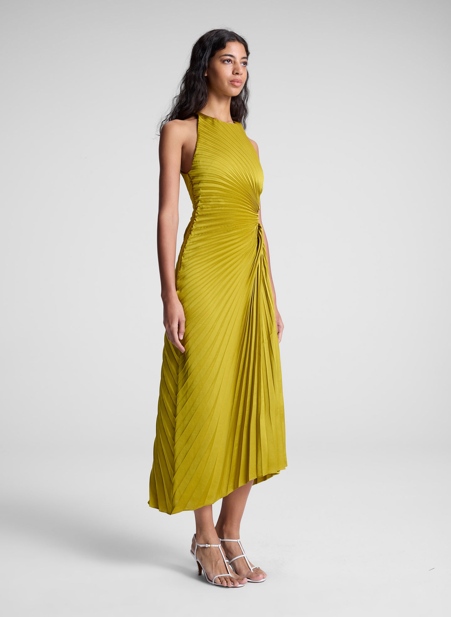 woman wearing pleated satin dress in yellow