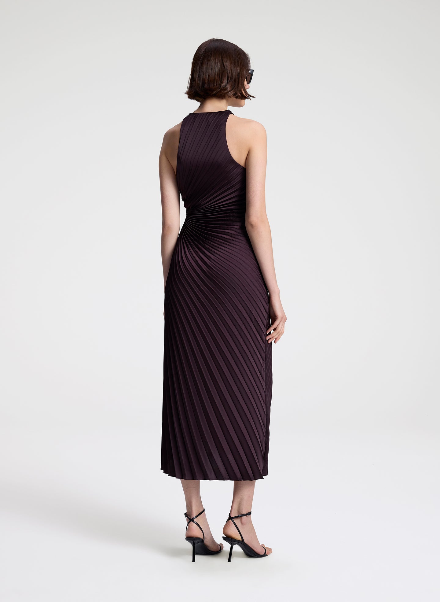 woman wearing purple pleated midi dress