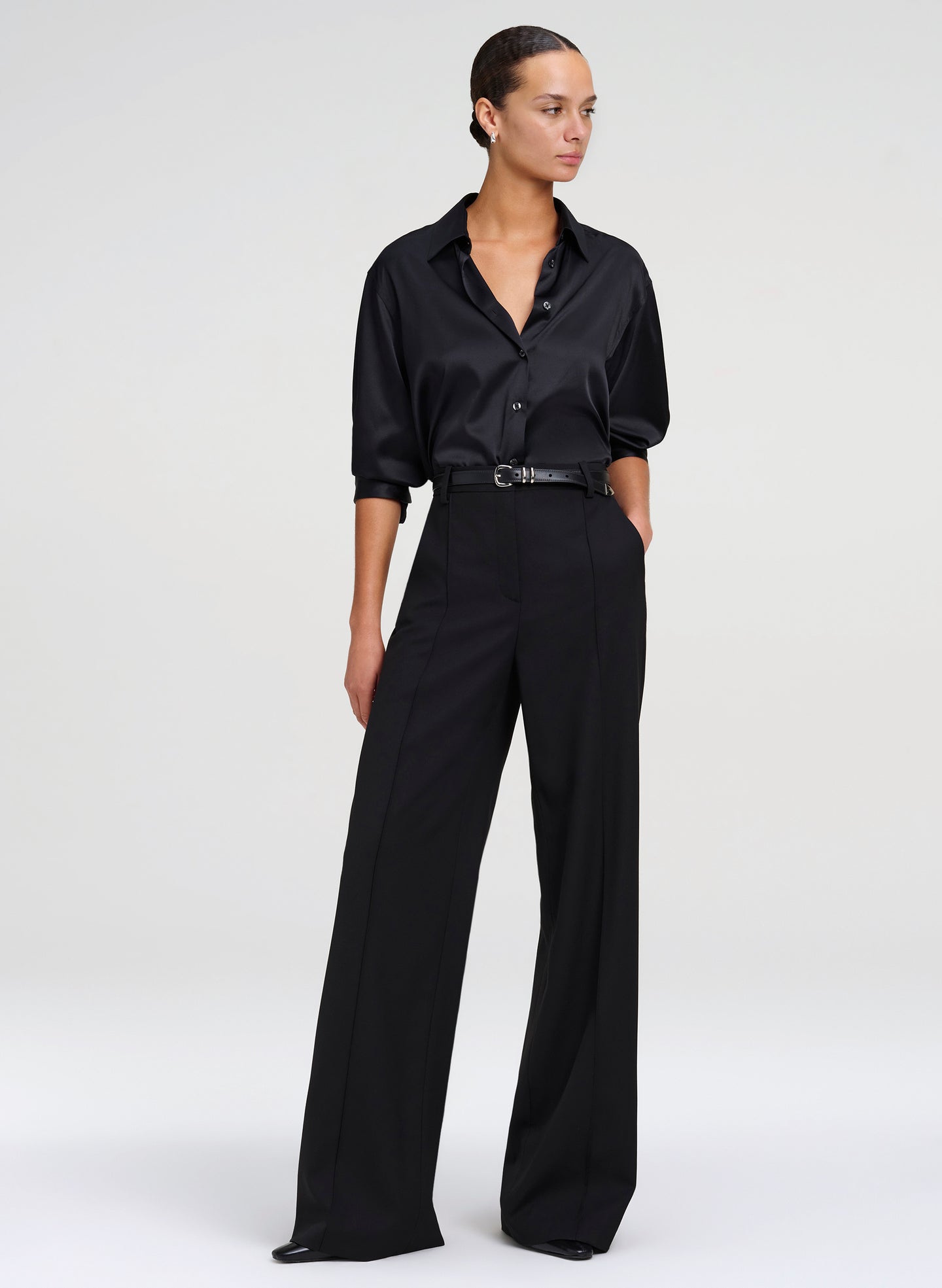 woman wearing black silk shirt and black wide leg pants