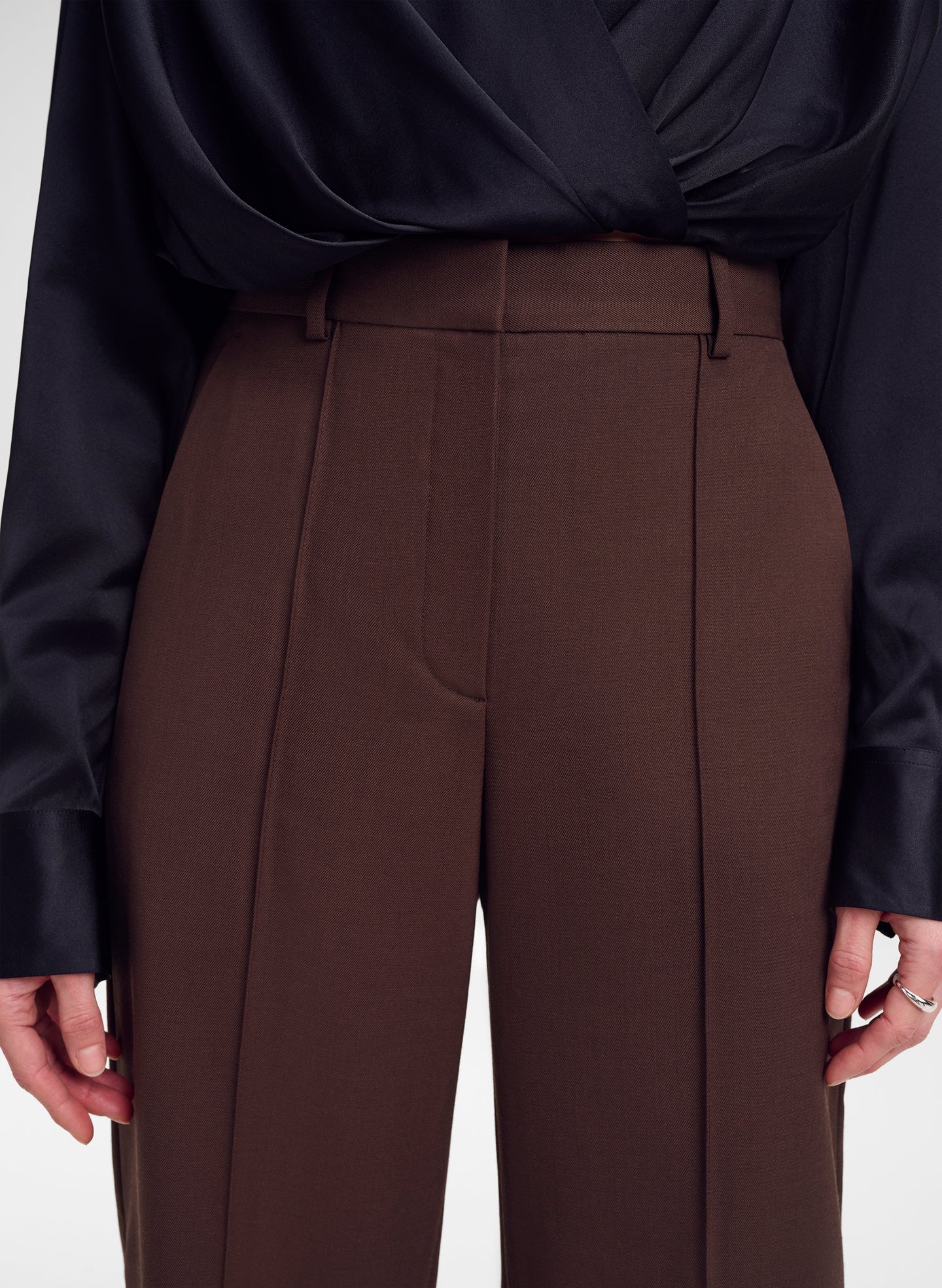 woman wearing brown pants and black silk top