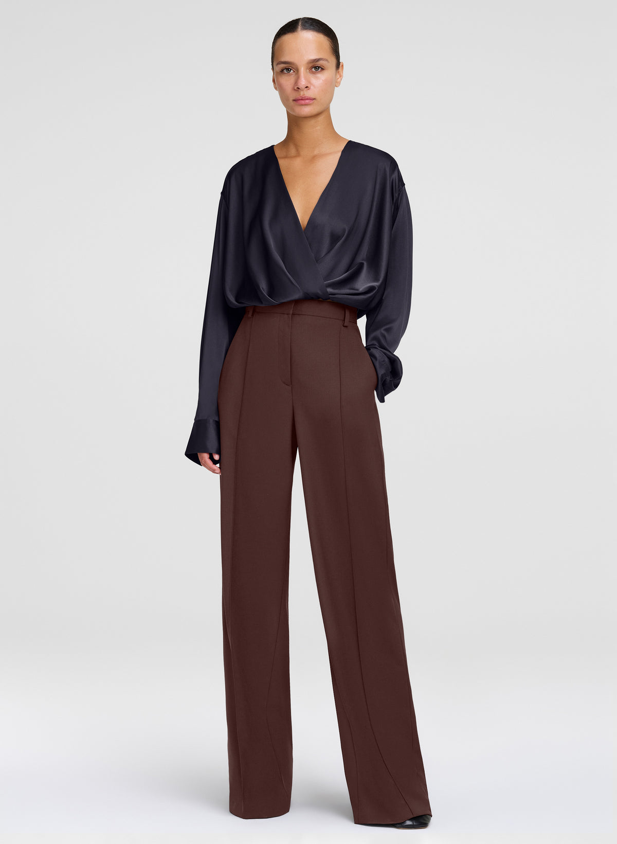 woman wearing brown pants with black silk top