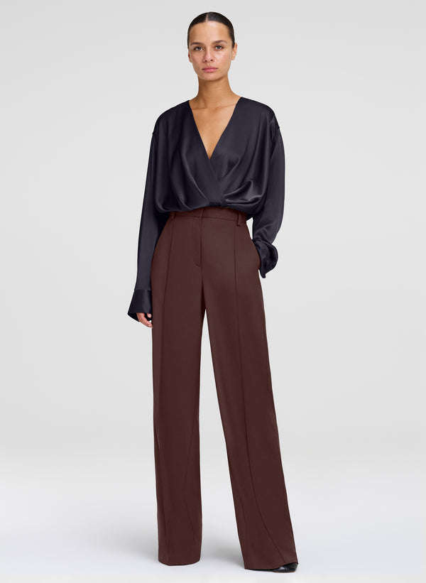 woman wearing brown pants with black silk top