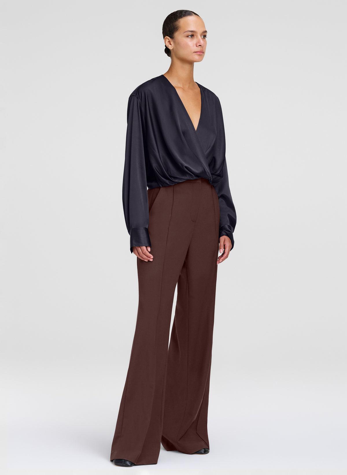 woman wearing brown pants and black silk top
