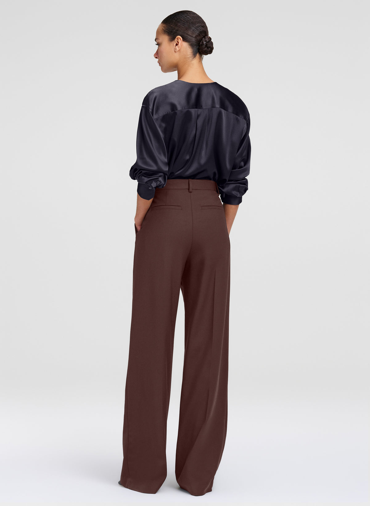 woman in brown pants and black top