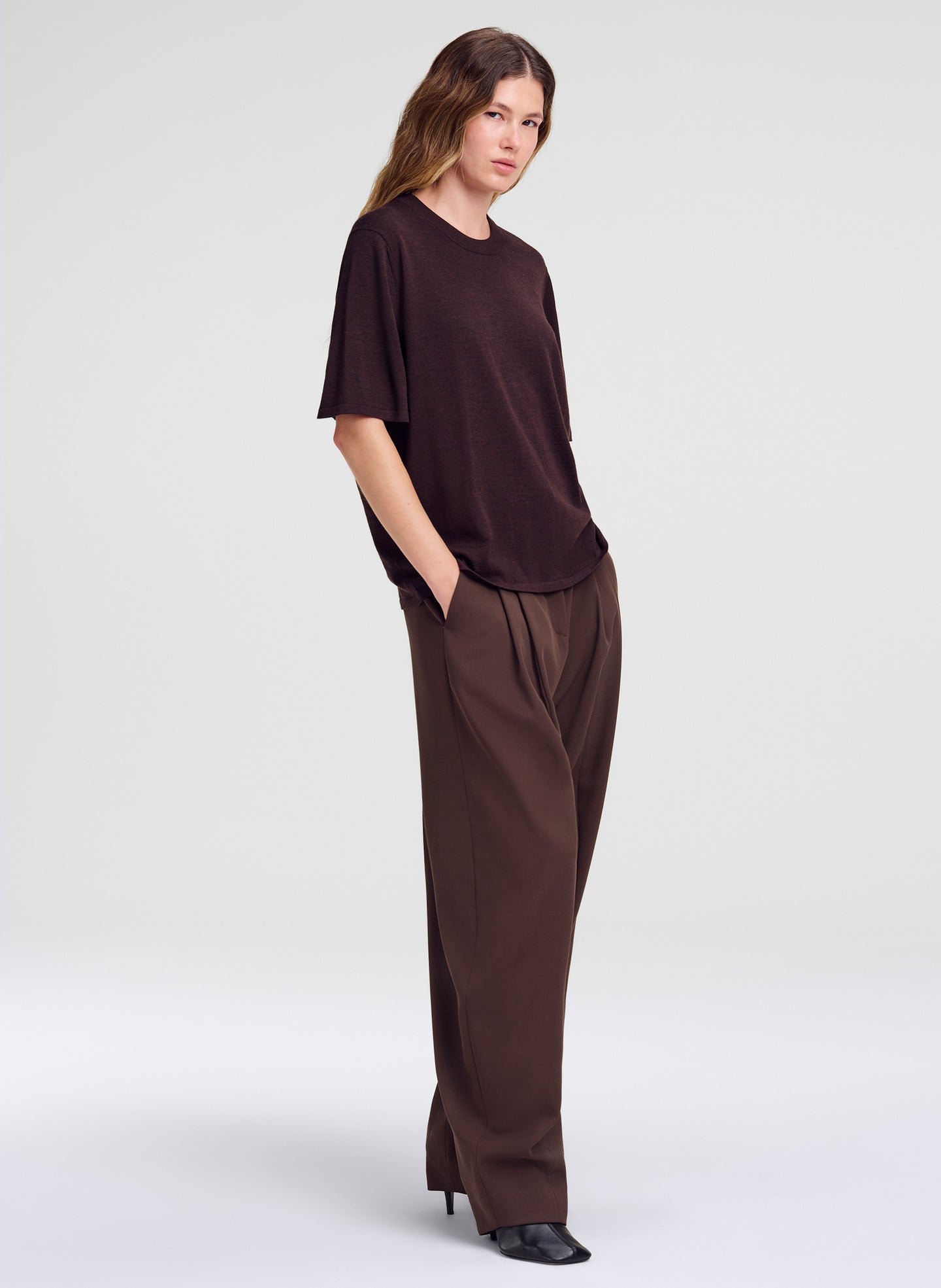 woman in brown outfit - merino top and pleated pant