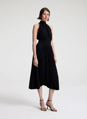 woman wearing black pleated midi dress