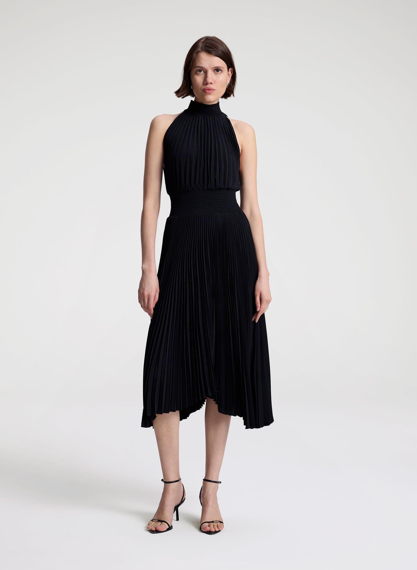 woman wearing black pleated midi dress