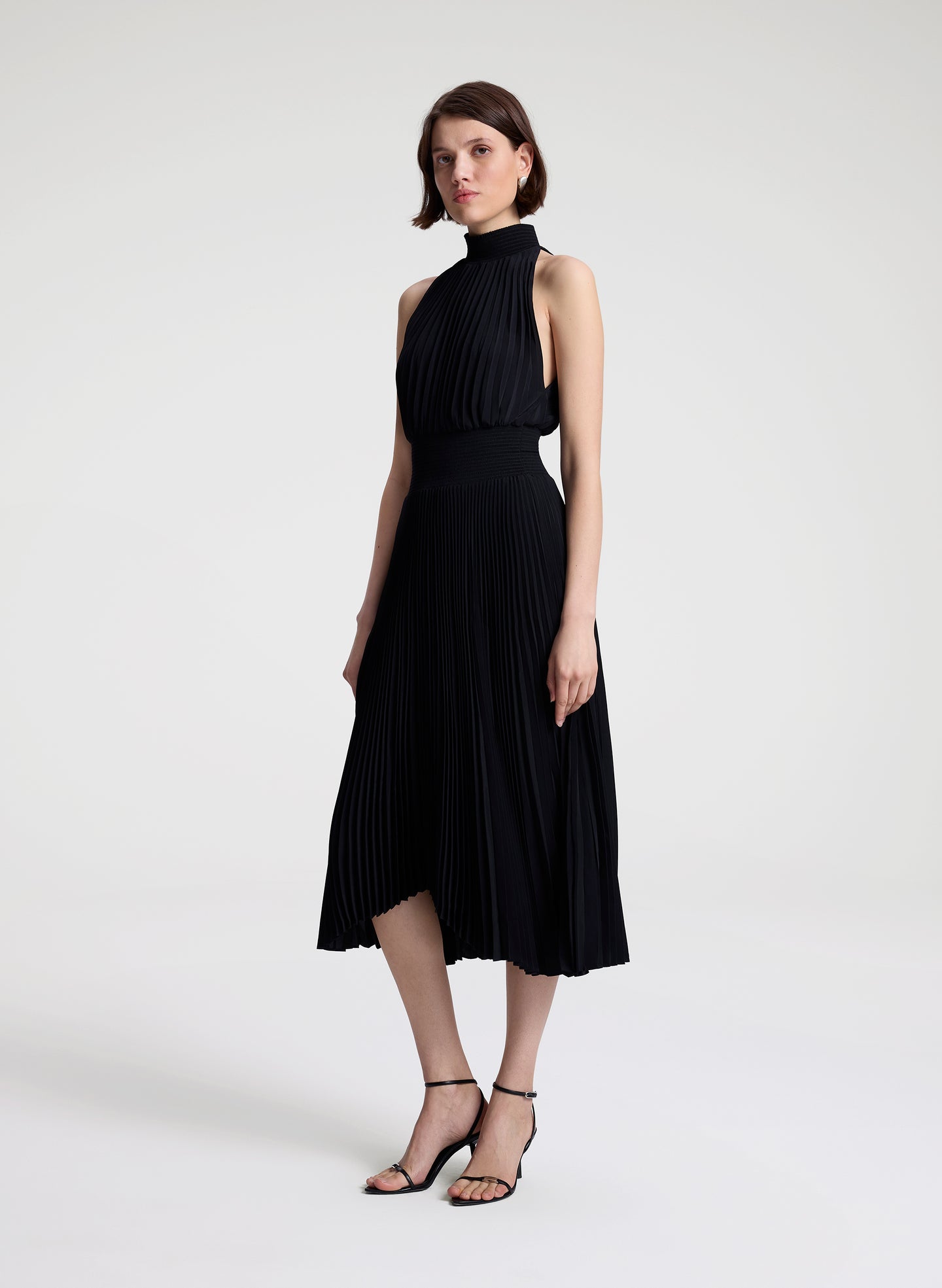woman wearing black pleated midi dress