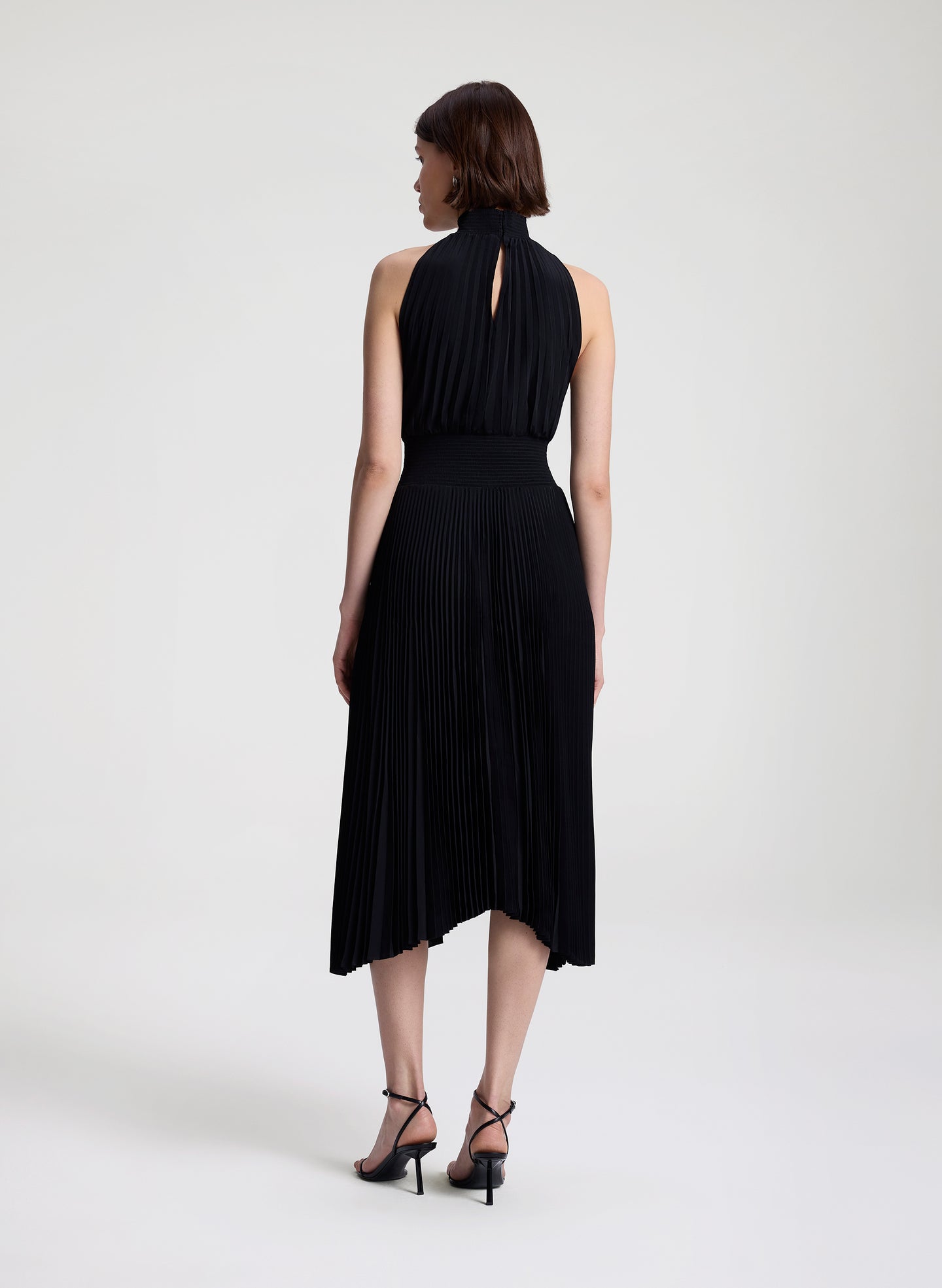 woman wearing black pleated midi dress
