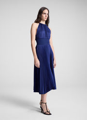 woman wearing blue pleated midi dress