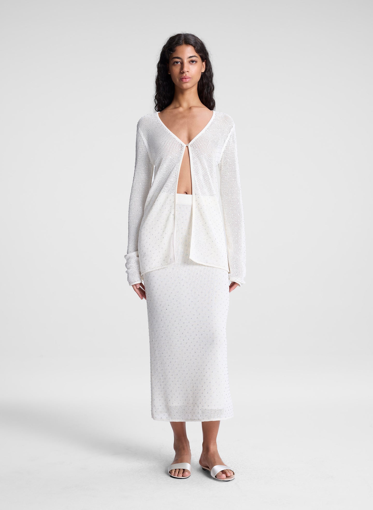 woman wearing sheer white cardigan and white maxi skirt