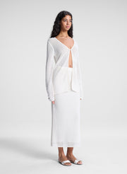 woman wearing sheer white cardigan and white maxi skirt