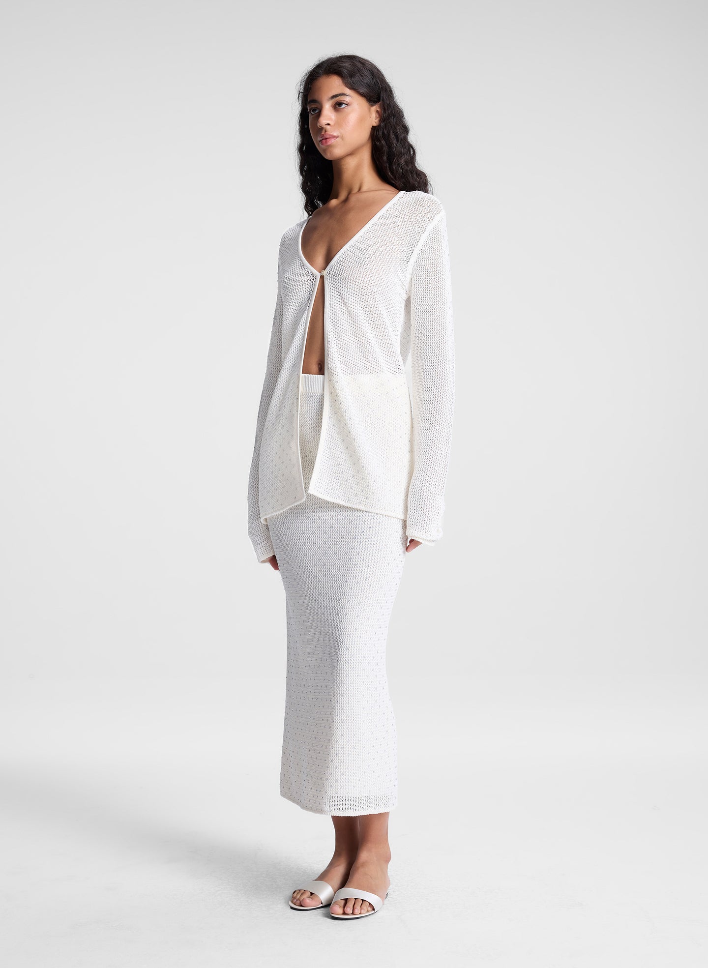 woman wearing sheer white cardigan and white maxi skirt