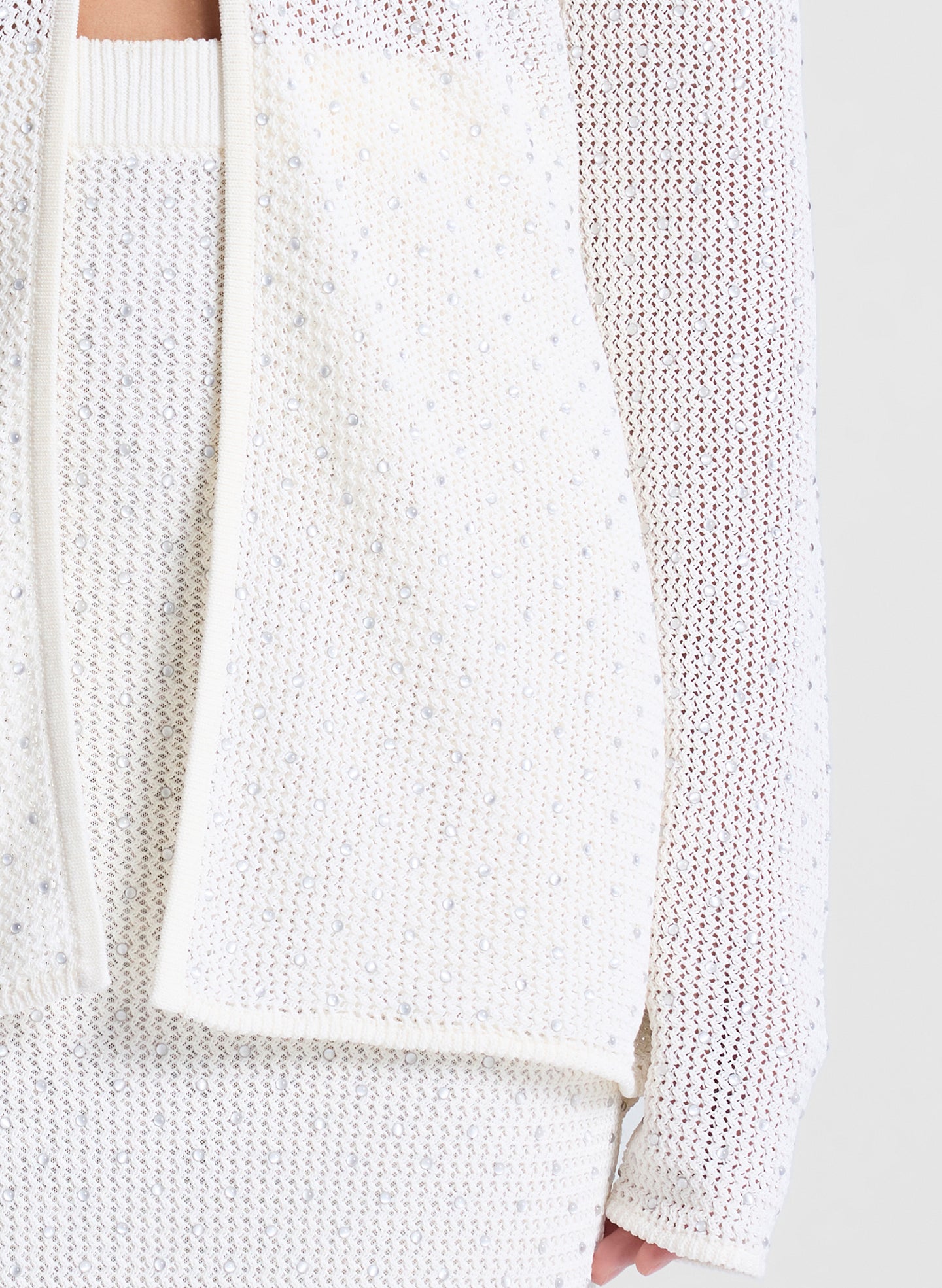 woman wearing sheer white cardigan and white maxi skirt