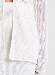 woman wearing sheer white cardigan and white maxi skirt