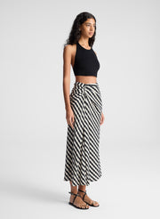 woman wearing black tank top and black and tan gingham skirt