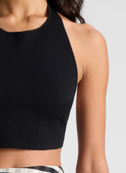 woman wearing black tank top and black and tan gingham skirt