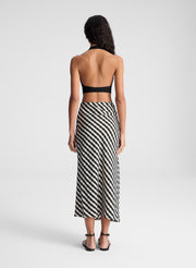 woman wearing black tank top and black and tan gingham skirt